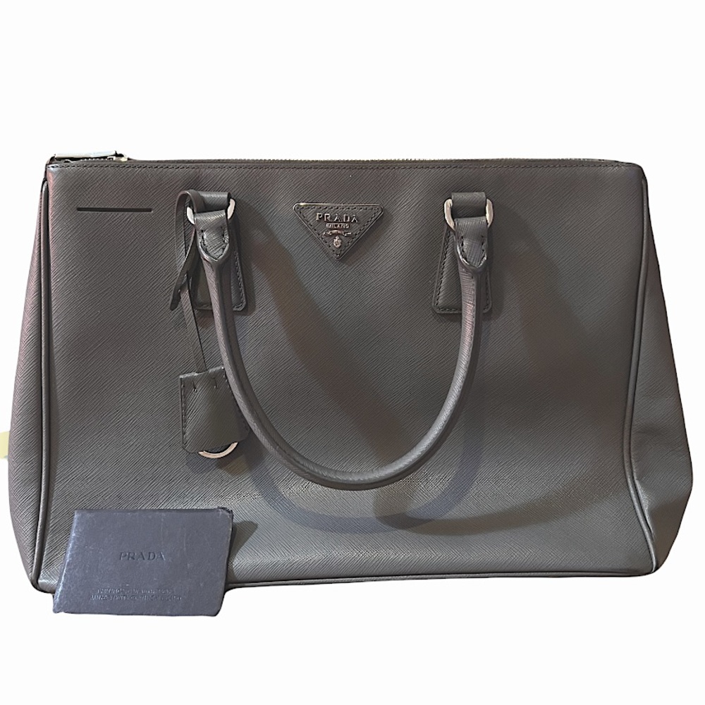 Gray Prada bag. Comes with verification card.